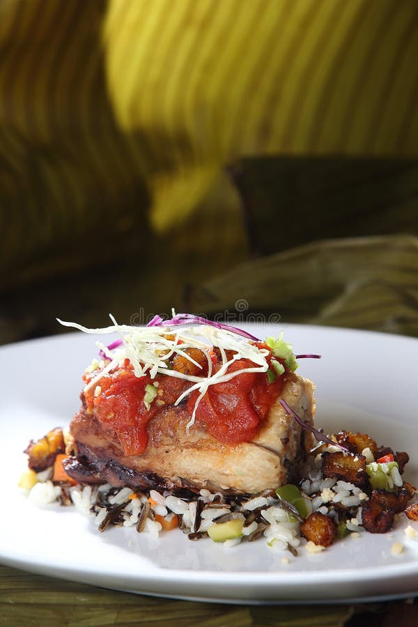 Roast Pork Tenderloin Served on Wild Rice and Fried Plantain Chips and