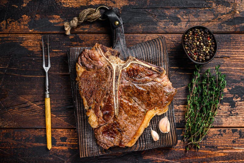 Roast T-bone or Porterhouse Beef Meat Steak on a Wooden Cutting Board ...