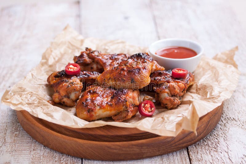 Roasted barbecue chicken wings with bbq sauce, italian herbs, olive oil and pepper