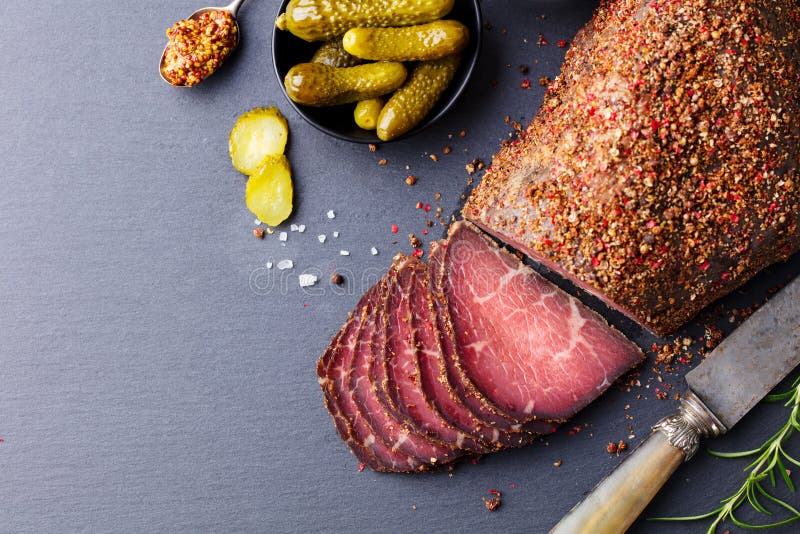 Roasted beef, pastrami on slate cutting board. Top view. Copy space. royalty free stock photography Roasted beef, pastrami on slate cutting board. Top view. Copy space. royalty free stock photography