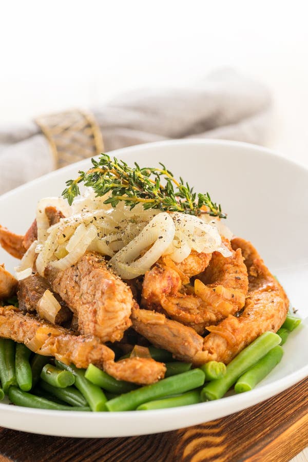 Roasted Beef or Pork Meat Slices with a Side Dish of Green Vegetables