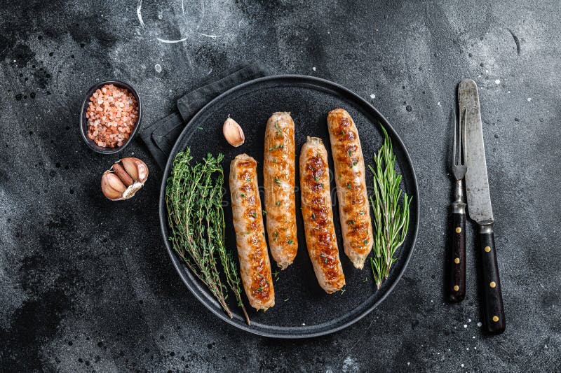 Roasted Bockwurst Pork Meat Sausages in a Plate. Black Background Stock