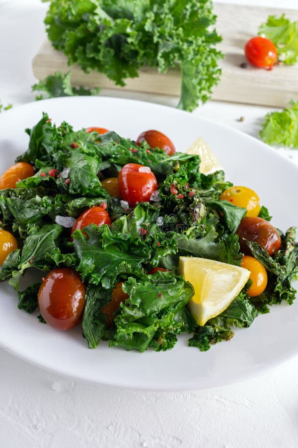 Roasted Cabbage with Kale and Cherry Tomatoes and Lemon Slices Stock