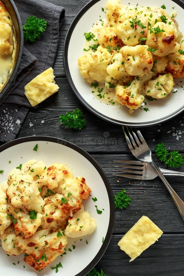 Roasted Cauliflower with Cheddar Cheese Sauce and Herbs. Stock Image