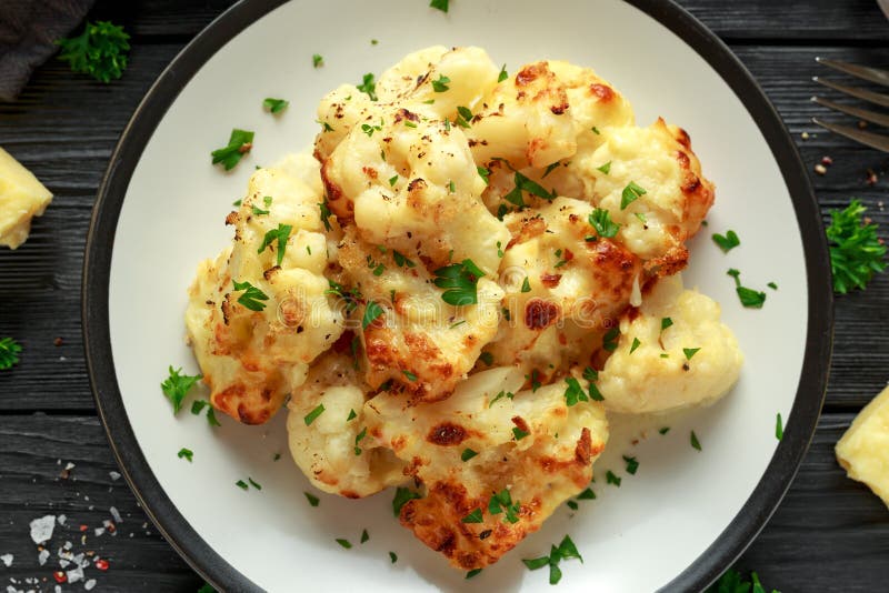 Roasted Cauliflower with Cheddar Cheese Sauce and Herbs. Stock Photo