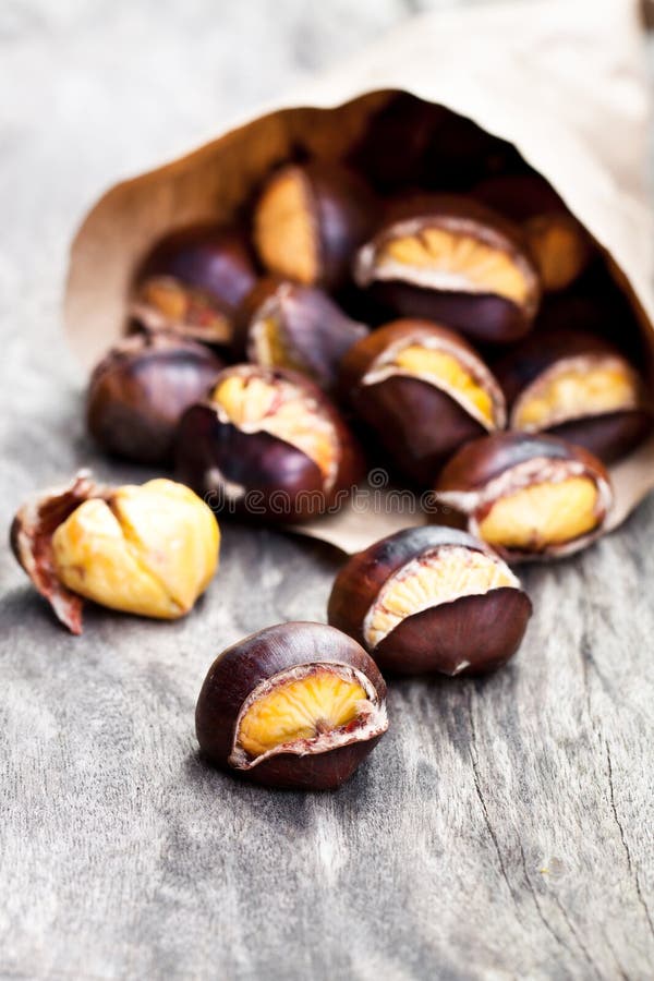 Roasted Chestnuts on Wooden Background Stock Image - Image of dried