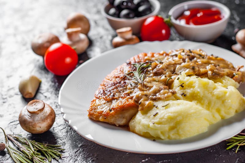 Roasted Chicken Breast with Mushroom Sauce and mashed potato in white plate