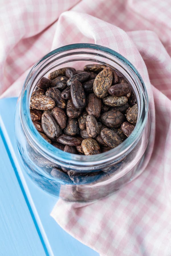Roasted cocoa beans in jar stock image. Image of aromatic 214724901