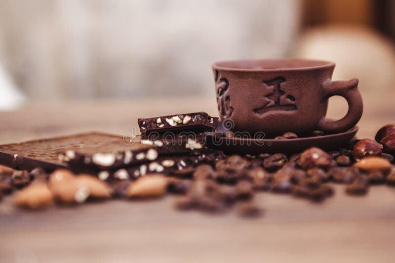 Roasted Coffee Beans with Chocolate and Nuts on a Wooden Surface. Stock