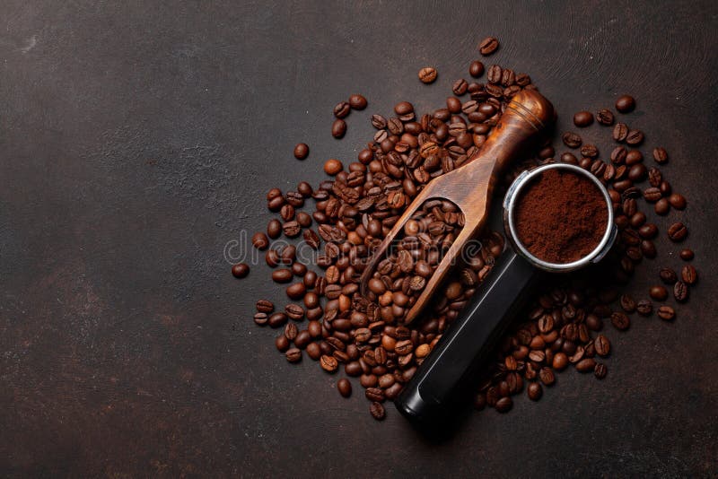 Roasted Coffee Beans and Ground Coffee in Filter Holder Stock Photo