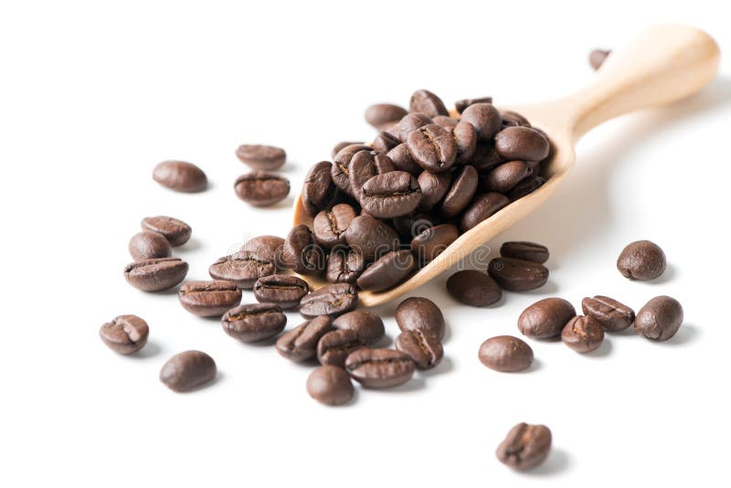 Roasted coffee beans in wood scoop isolated