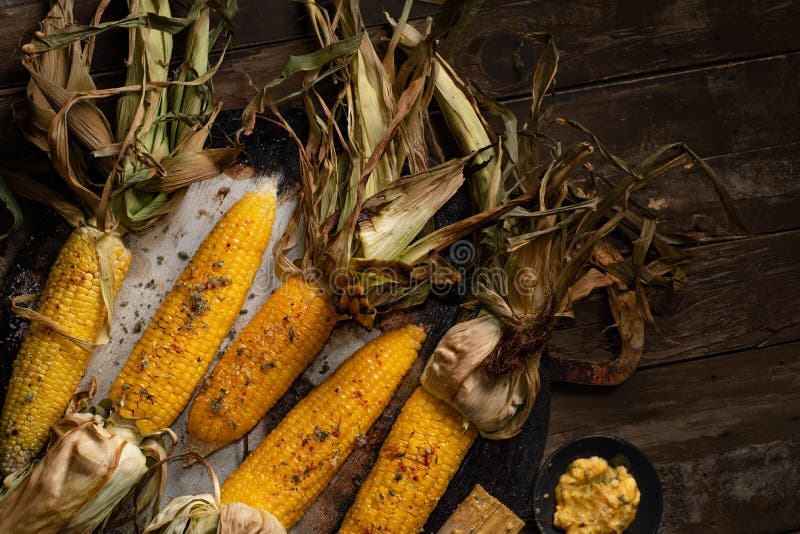 Roasted corn with husks stock image. Image of grain 259459101