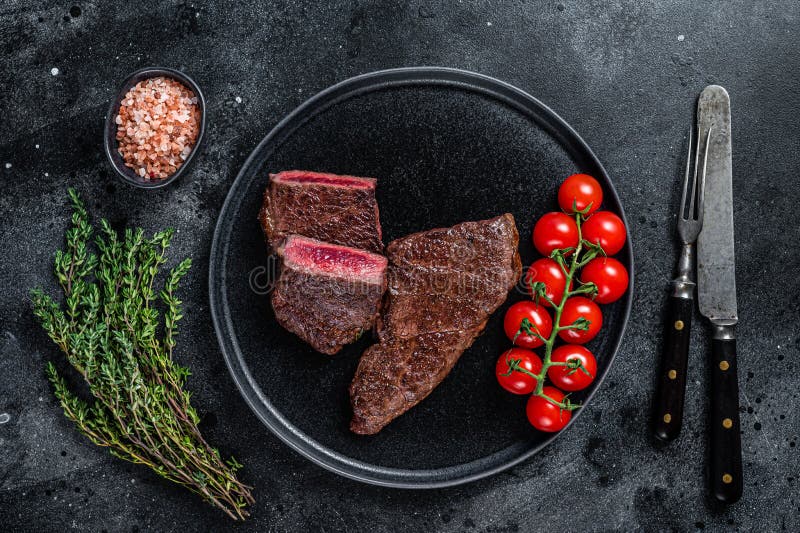 Roasted Cut Denver Beef Meat Steak on a Plate with Thyme. Black Background Stock Image Image