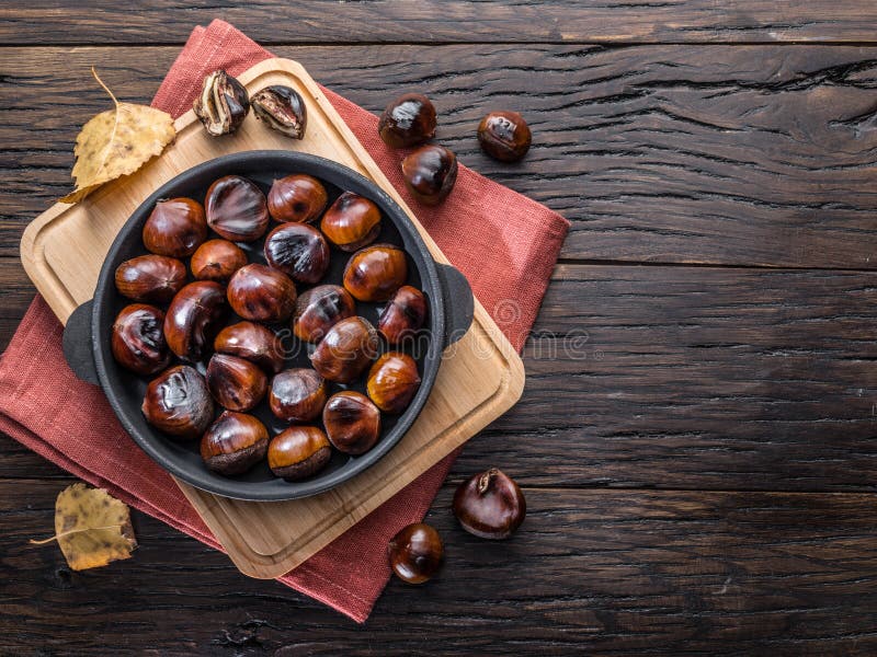 Roasted edible chestnut fruits in the pan. Top view stock image