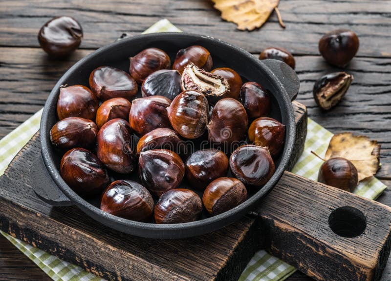 Roasted edible chestnut fruits in the pan. Top view stock image