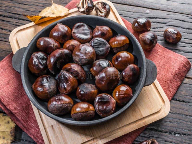 Roasted edible chestnut fruits in the pan. Top view royalty free stock photography