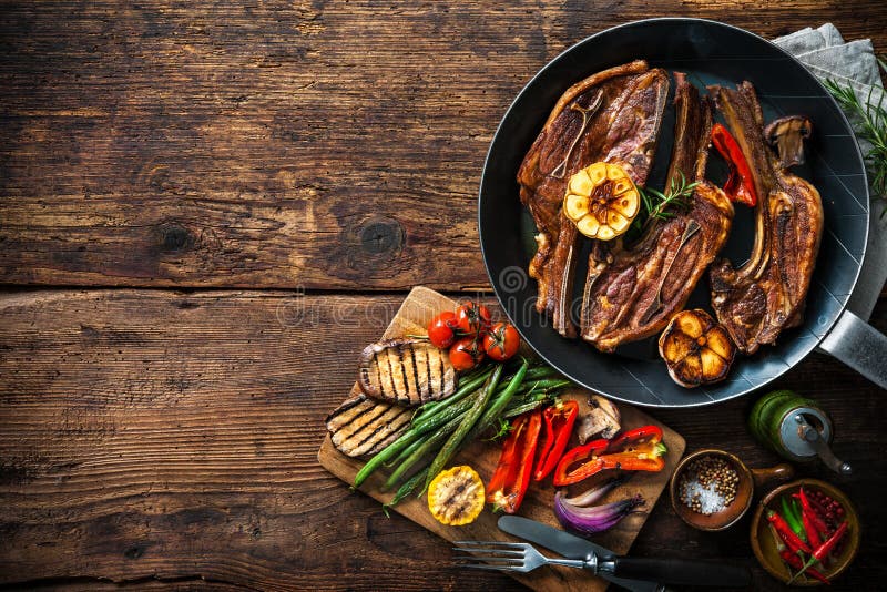 Roasted lamb meat with vegetables on grill pan