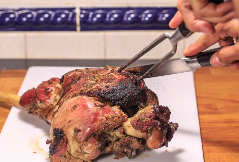 A roasted leg of lamb being carved stock photo A roasted leg of lamb being carved stock photo