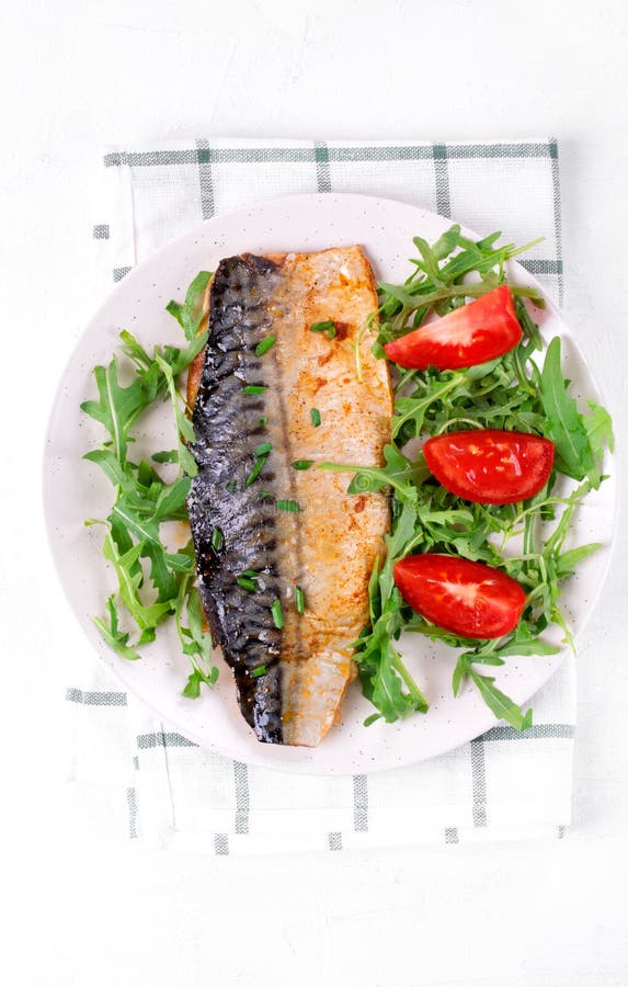 Roasted Mackerel Served with Arugula and Tomatoes Stock Photo Image