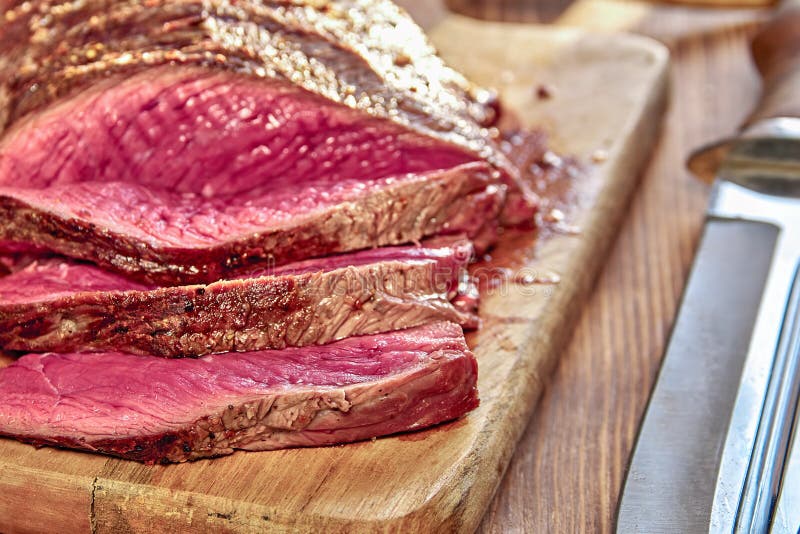 Roasted Meat with Blood. Well-Done Steak Closeup. Wooden Background ...