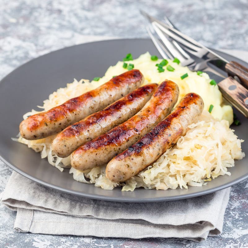 Roasted Nuremberg Sausages Served with Sour Cabbage and Mashed Potatoes
