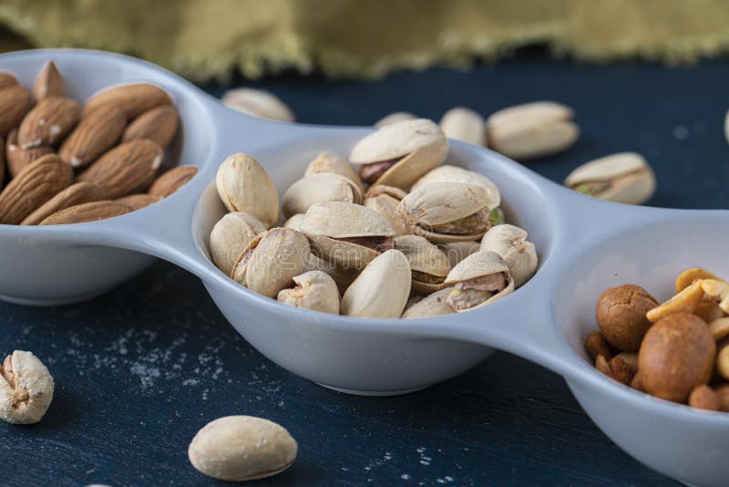 Roasted Nuts and Salted Pistachios in White Ceramic Bowl Stock Image