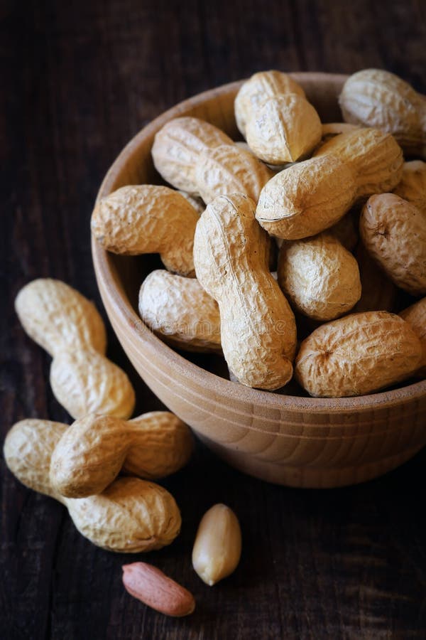 Roasted peanuts in bowl stock photo. Image of wood, butter 56230478