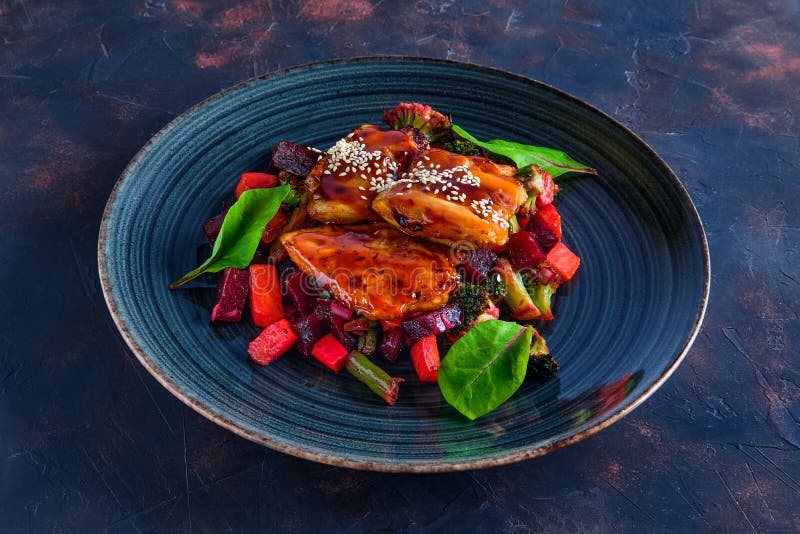 Roasted pike with beetroot, carrot, broccoli and balsamic sauce stock photography