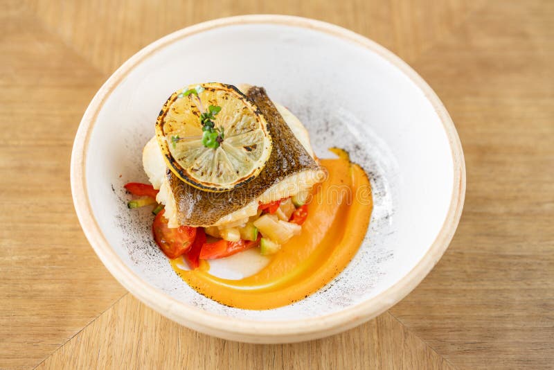 Roasted Pike Perch or Cod Fish with Baked Vegetables. Dish Decorated