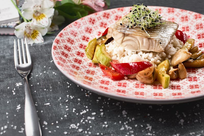 Roasted Pike perch perch with vegetables and rice risotto royalty free stock images