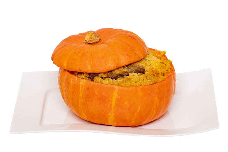 Roasted pumpkin. Close-up of baked whole pumpkin stuffed with roasted rice pot made from rice, onions, carrots, garlic, pumpkin stock photo Roasted pumpkin. Close-up of baked whole pumpkin stuffed with roasted rice pot made from rice, onions, carrots, garlic, pumpkin stock photo