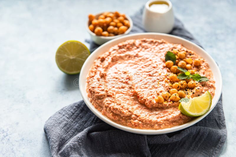 Roasted Red Pepper Hummus Garnish with Mint and Lime. Mashed Chickpeas