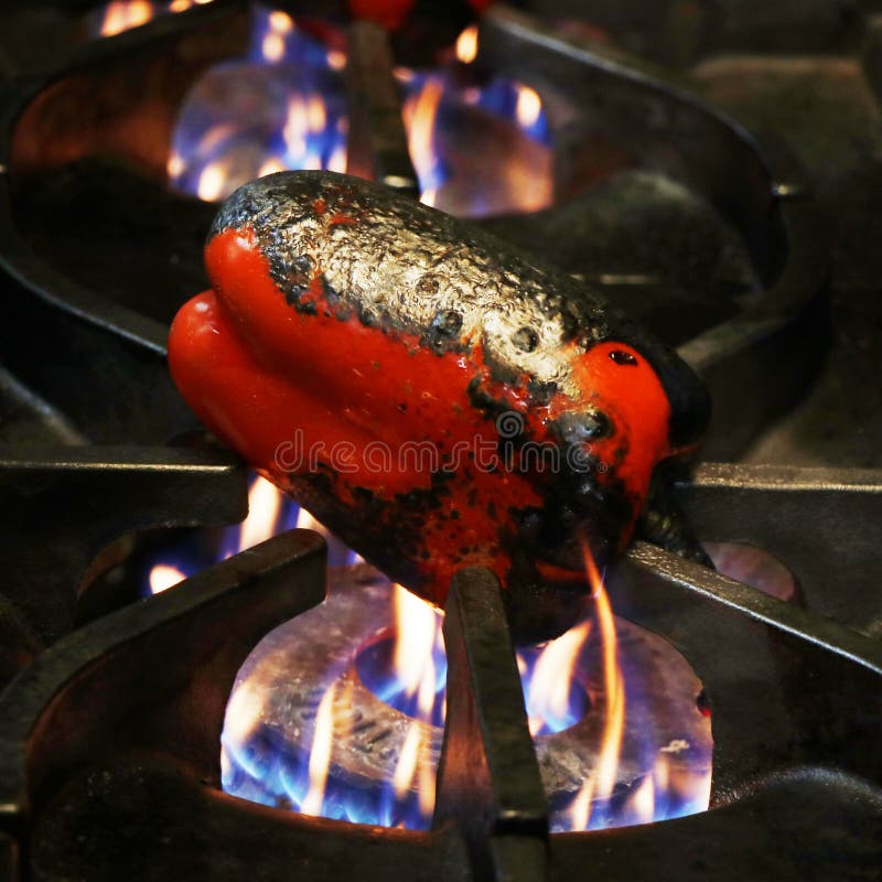 Roasted Red Peppers Preparation, on Direct Fire in a Kitchen Stock