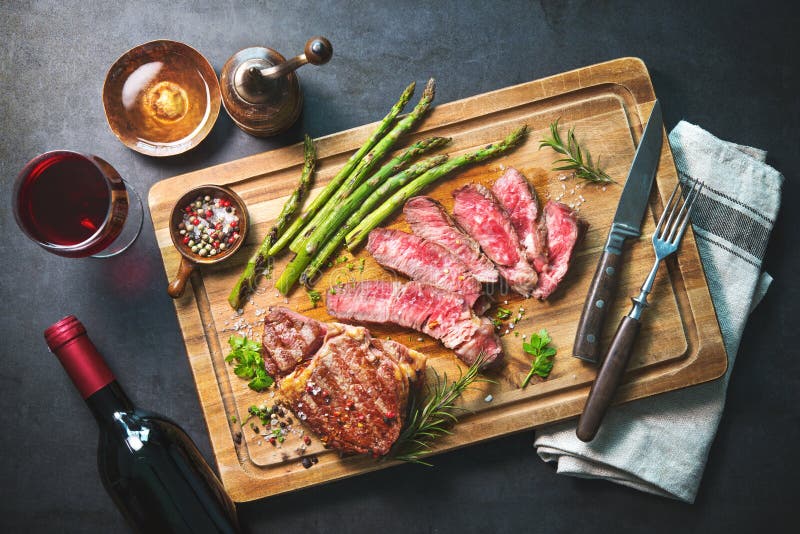 Roasted rib eye steak with green asparagus and wine stock images Roasted rib eye steak with green asparagus and wine stock images