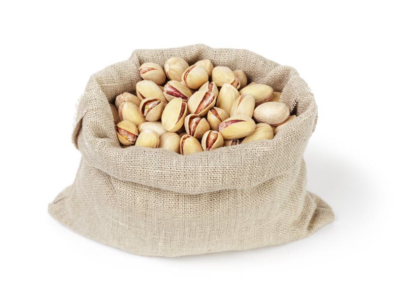 Roasted salty pistachios nuts in sack bag royalty free stock photo.