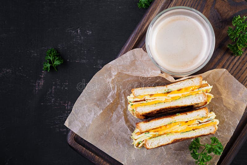 Roasted Sandwich Cheese and Scrambled Eggs on Paper with Coffee Stock Photo - Image of appetizer, fastfood: 234973500