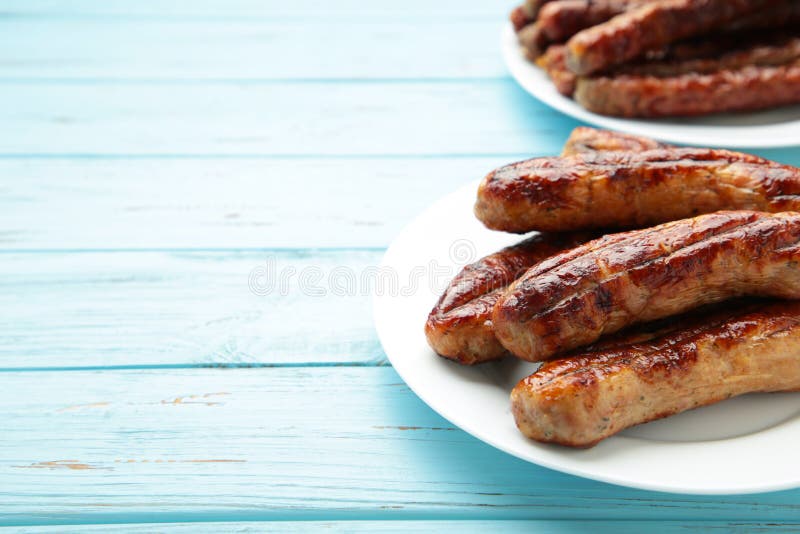 Roasted Sausage on Plate on Blue Background with Copy Space Stock Image