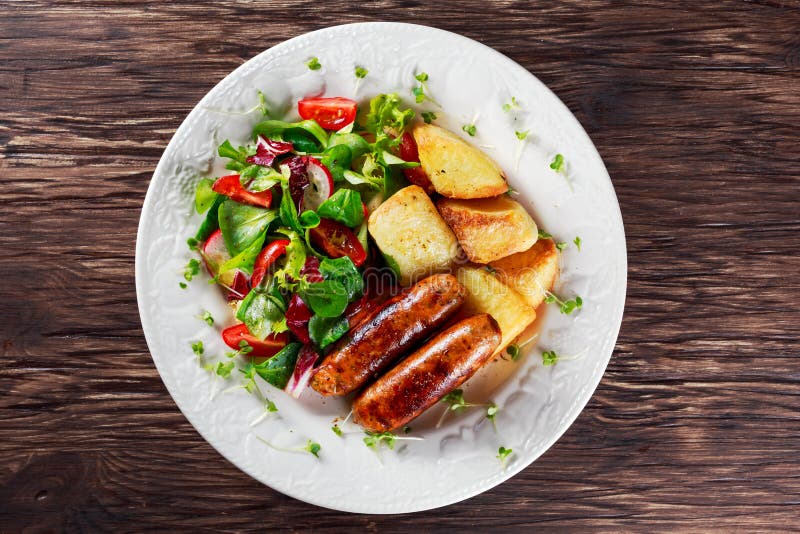 Grilled Sausages, Chips And Vegetable Salad Stock Photo Image of