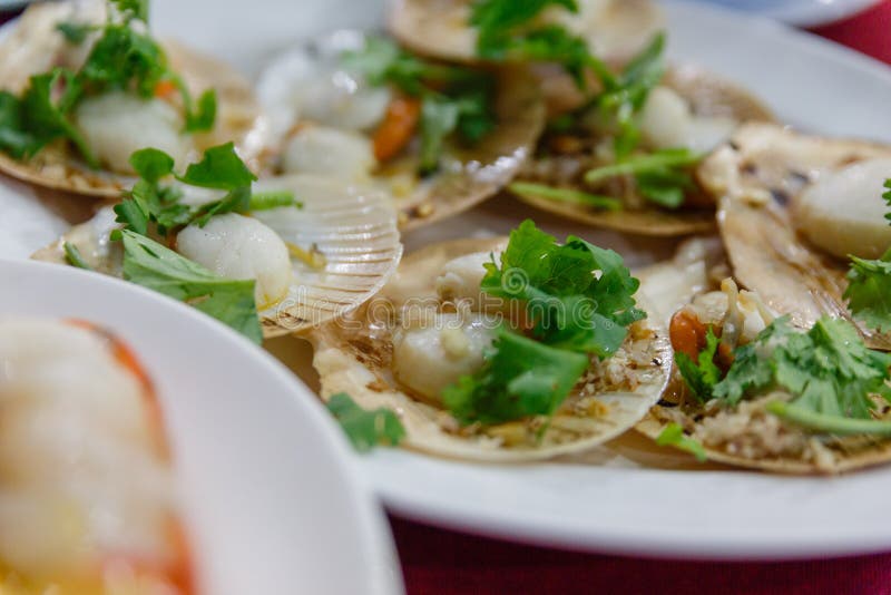 Roasted Scallops with Butter and Garlic. Topping with Coriander Stock