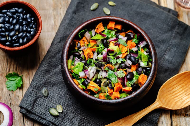 Roasted sweet potato black bean pepita avocado salad stock image Roasted sweet potato black bean pepita avocado salad stock image