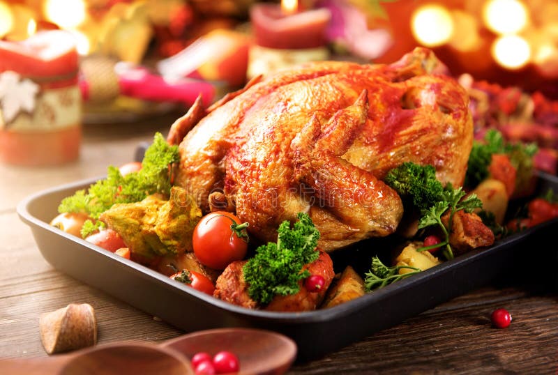 Roasted turkey garnished with potato, vegetables and cranberries. Thanksgiving or Christmas dinner. Roasted turkey garnished with potato, vegetables and cranberries. Thanksgiving or Christmas dinner