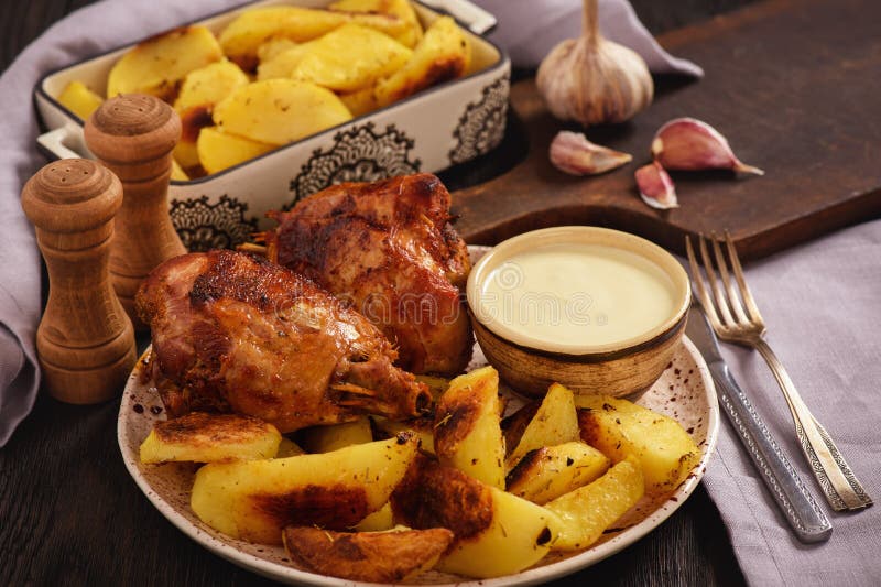 Roasted Turkey Knuckles with Baked Potatoes. Stock Image Image of