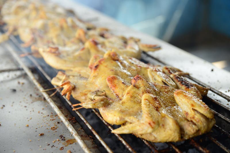 Roasting the Whole Chicken on the Grill in Asian Restaurant Stock Photo