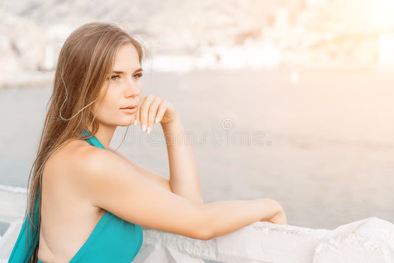 Robe verte pour femme sea trevel. vue latérale une femme heureuse avec des cheveux longs en robe de menthe longue posant sur une p photos libres de droits