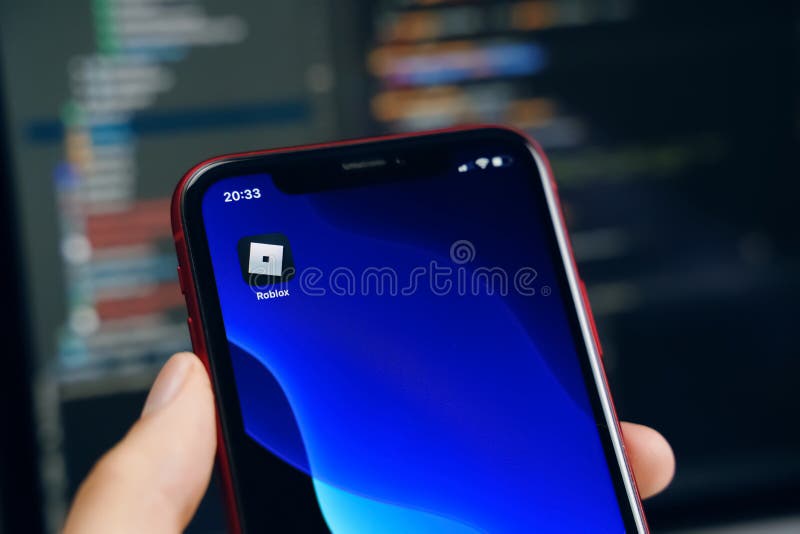 Roblox Logo and App on a Mobile Screen in a Hand Editorial Stock