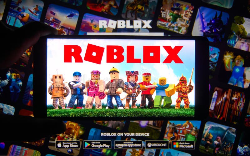 Roblox logo and app on a mobile screen in a hand