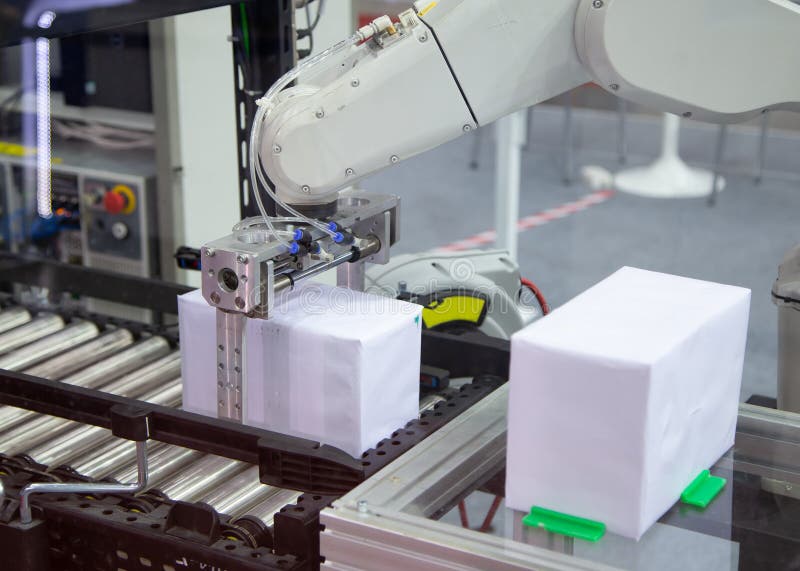 Industry automated robot arm loading and unloading box in production line. Industry automated robot arm loading and unloading box in production line