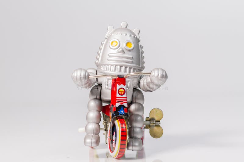 A Robot Toy is Riding Bicycle Stock Image Image of face, bicycle