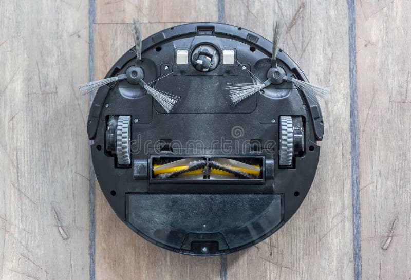 Bottom of a Robot Vacuum Cleaner Wheels and Brushes Stock Photo