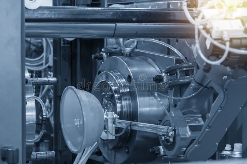 The robotic arm keep the plastic blow part from the injection machine . royalty free stock photography The robotic arm keep the plastic blow part from the injection machine . royalty free stock photography